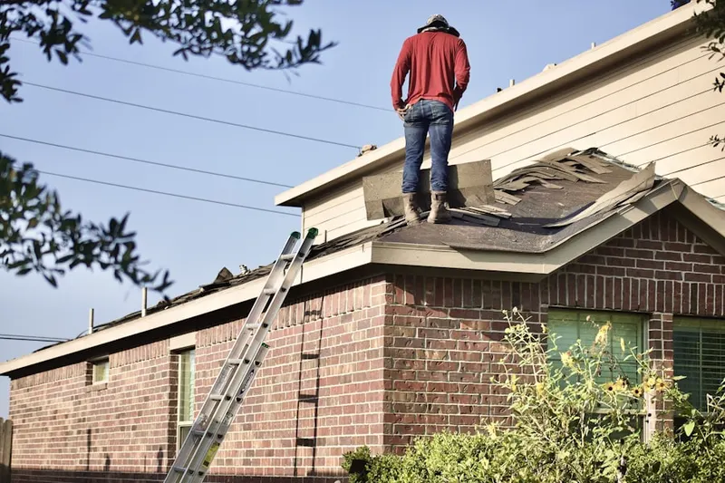 Professional roofer working on a residential roof in Foothill Acres
